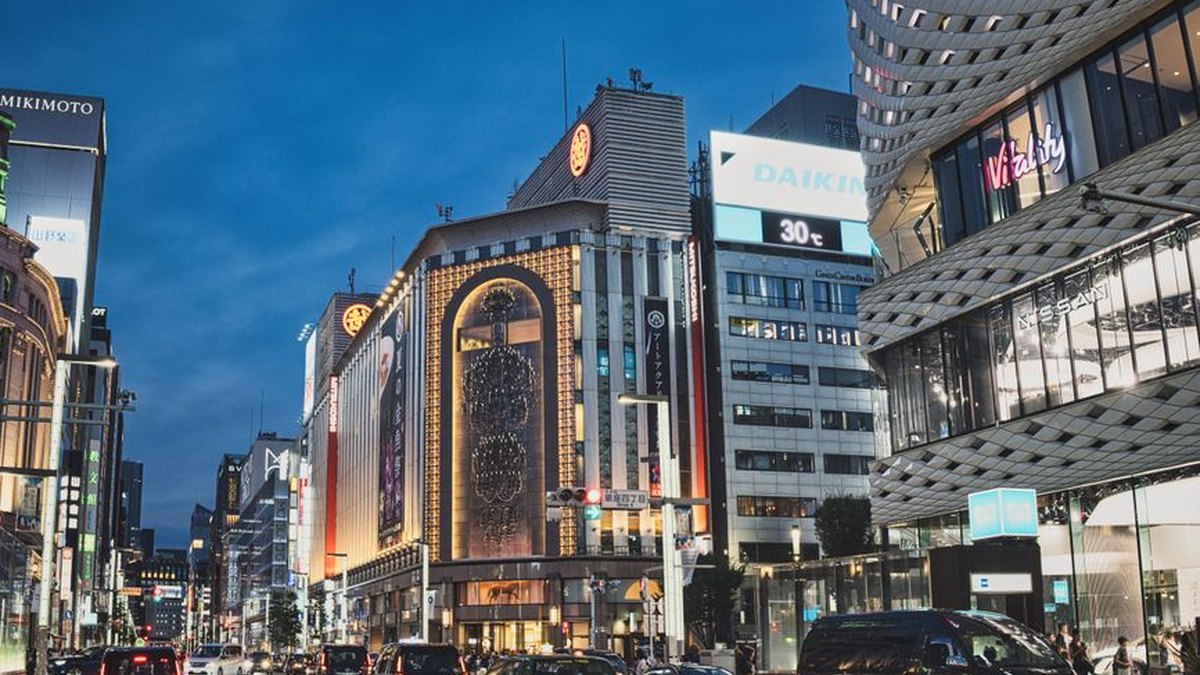 A bustling evening view of the famous Ginza district in Tokyo, showcasing vibrant city life and architecture.