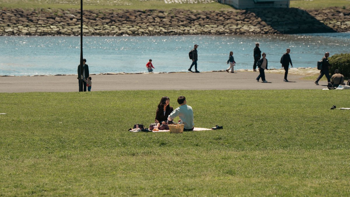 A family relaxing at a riverside park in Tokyo